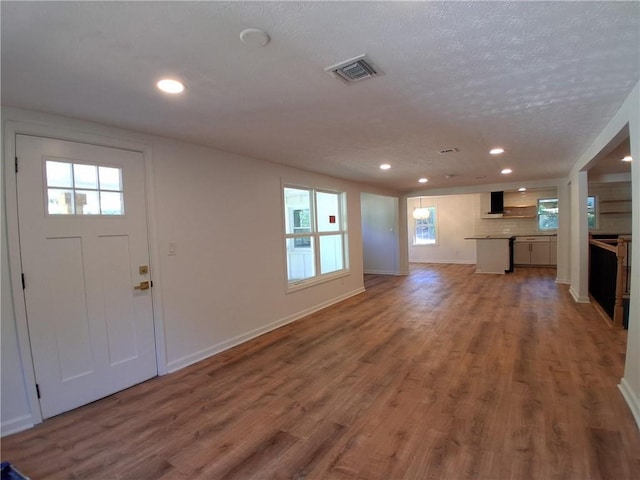 816 Stewart St, Carrollton, GA 30117 - entryway with recessed lighting, a healthy amount of sunlight, light wood-style flooring, visible vents, and a textured ceiling