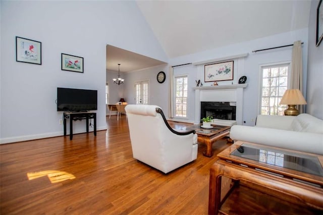 2003 Hubbard Ct, Villa Rica, GA 30180 - living room featuring a chandelier, wood finished floors, plenty of natural light, and high vaulted ceiling