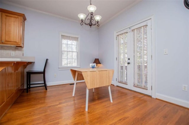 2003 Hubbard Ct, Villa Rica, GA 30180 - dining space with light wood-style floors, crown molding, a chandelier, baseboards, and an office area
