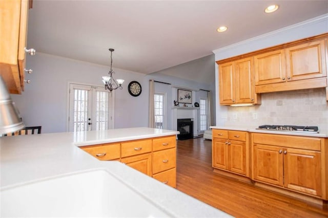 2003 Hubbard Ct, Villa Rica, GA 30180 - kitchen with wood finished floors, light countertops, a fireplace, backsplash, and recessed lighting