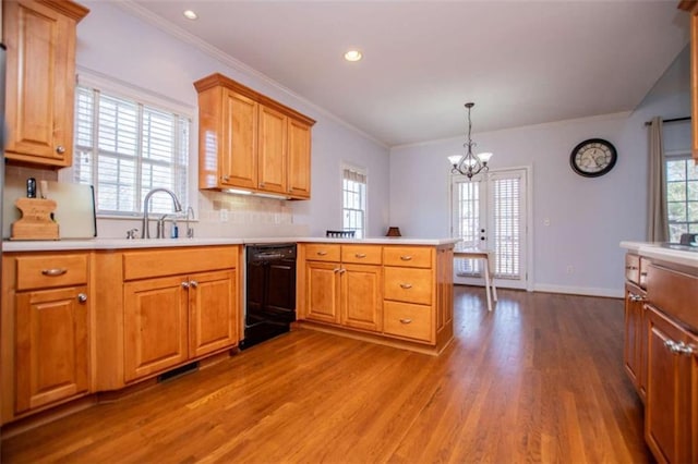 2003 Hubbard Ct, Villa Rica, GA 30180 - kitchen featuring dishwasher, a sink, a peninsula, wood finished floors, and a chandelier