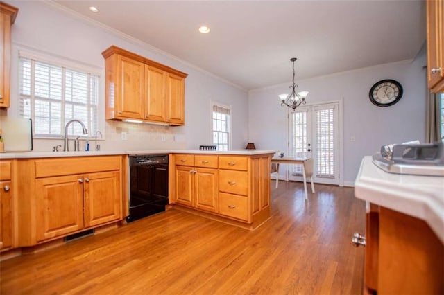 2003 Hubbard Ct, Villa Rica, GA 30180 - kitchen featuring black dishwasher, a peninsula, light wood finished floors, a chandelier, and a sink