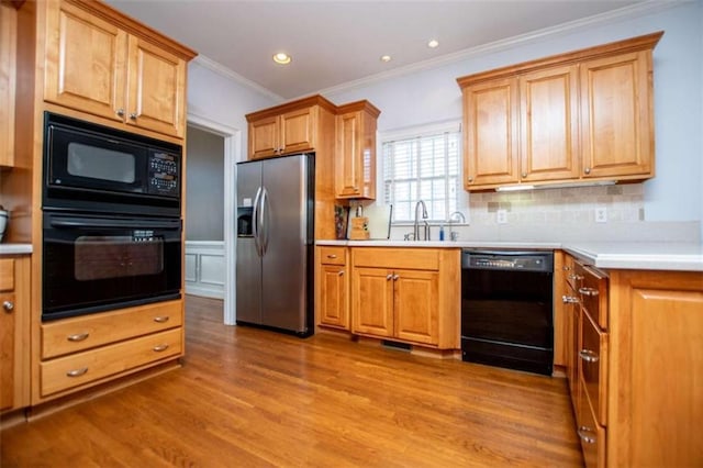 2003 Hubbard Ct, Villa Rica, GA 30180 - kitchen featuring black appliances, wood finished floors, crown molding, decorative backsplash, and light countertops