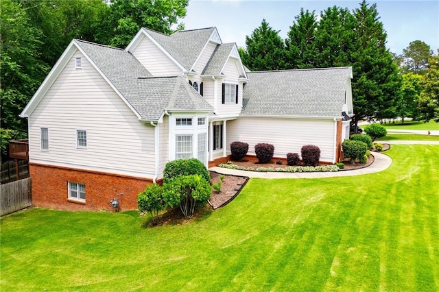 2003 Hubbard Ct, Villa Rica, GA 30180 - view of side of property featuring roof with shingles, a yard, view of scattered trees, and brick siding