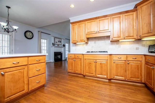 2003 Hubbard Ct, Villa Rica, GA 30180 - kitchen with a chandelier, a fireplace, light wood-style flooring, light countertops, and crown molding