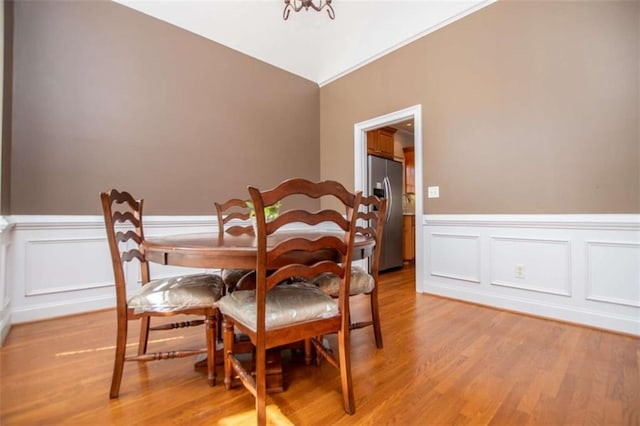 2003 Hubbard Ct, Villa Rica, GA 30180 - dining room with light wood-type flooring, a wainscoted wall, and a decorative wall