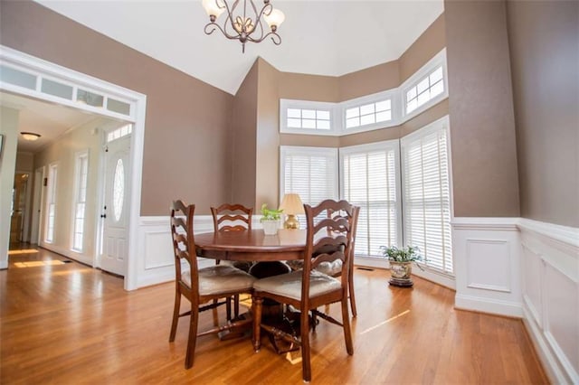 2003 Hubbard Ct, Villa Rica, GA 30180 - dining area with a decorative wall, a wainscoted wall, healthy amount of natural light, light wood finished floors, and a chandelier