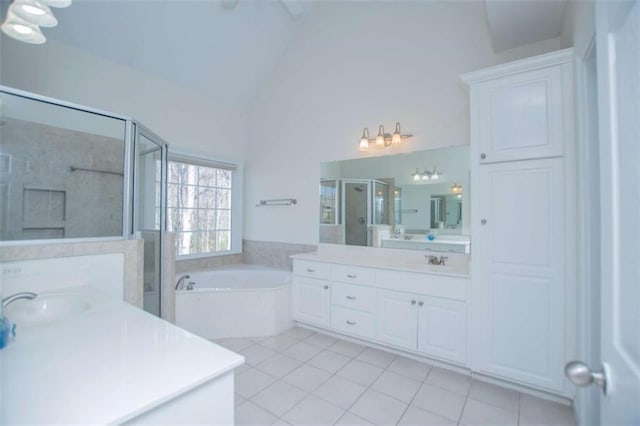 2003 Hubbard Ct, Villa Rica, GA 30180 - full bath featuring tile patterned floors, two vanities, a shower stall, vaulted ceiling, and a bath