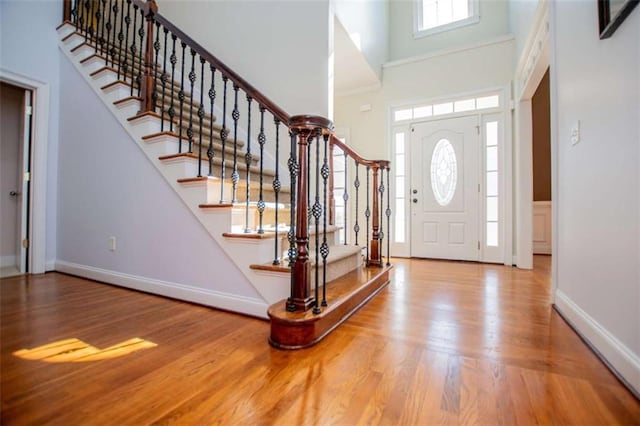 2003 Hubbard Ct, Villa Rica, GA 30180 - entrance foyer featuring wood finished floors, a towering ceiling, stairway, and baseboards