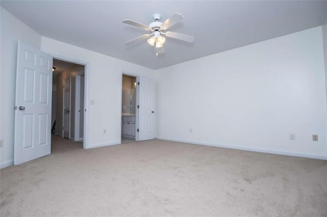 2003 Hubbard Ct, Villa Rica, GA 30180 - unfurnished bedroom featuring light carpet, baseboards, ceiling fan, and connected bathroom
