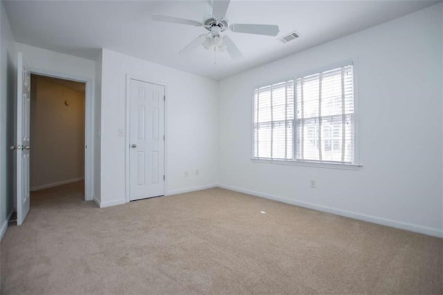 2003 Hubbard Ct, Villa Rica, GA 30180 - unfurnished bedroom with light colored carpet, multiple windows, baseboards, and a ceiling fan