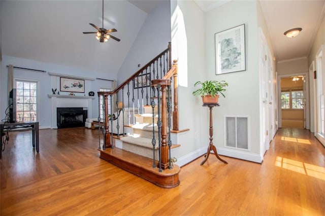 2003 Hubbard Ct, Villa Rica, GA 30180 - stairway with wood finished floors, ceiling fan, a fireplace, plenty of natural light, and high vaulted ceiling