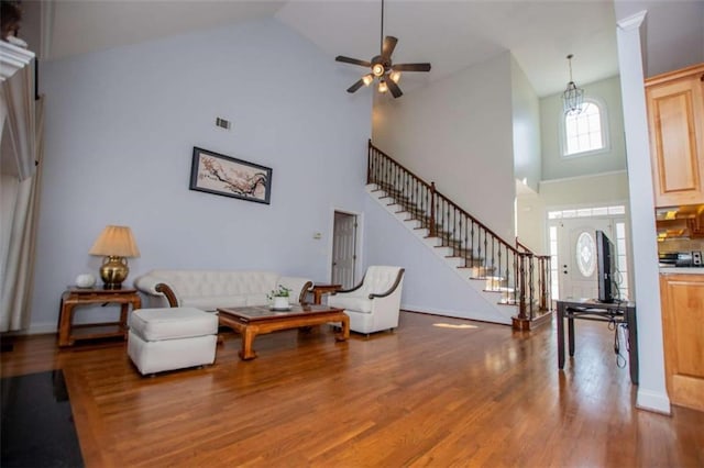 2003 Hubbard Ct, Villa Rica, GA 30180 - living room featuring high vaulted ceiling, stairway, wood finished floors, ceiling fan, and baseboards