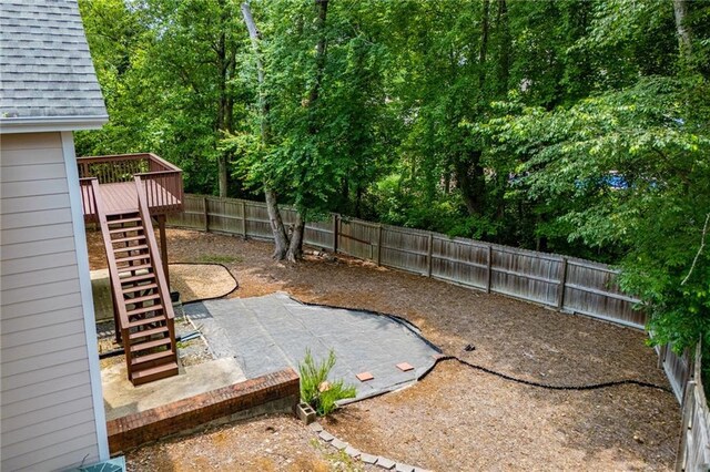 2003 Hubbard Ct, Villa Rica, GA 30180 - fenced backyard with stairway, a wooden deck, and a patio area