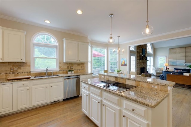 130 Hamilton Way, Roswell, GA 30075 - kitchen with stainless steel dishwasher, black electric stovetop, light wood-style floors, crown molding, and open floor plan