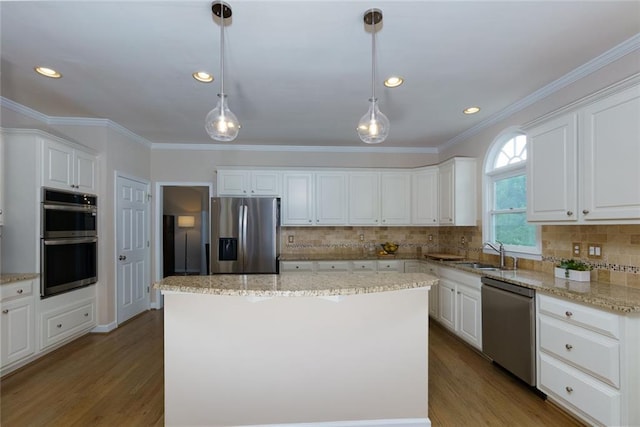 130 Hamilton Way, Roswell, GA 30075 - kitchen with stainless steel appliances, ornamental molding, wood finished floors, white cabinets, and a kitchen island