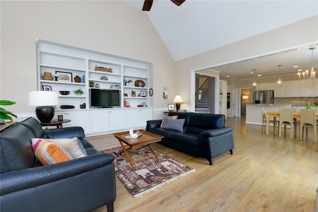 130 Hamilton Way, Roswell, GA 30075 - living area featuring light wood-type flooring, ceiling fan, high vaulted ceiling, a chandelier, and stairway
