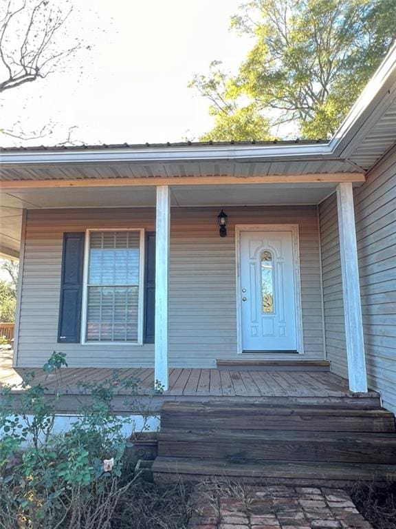 view of exterior entry with a porch