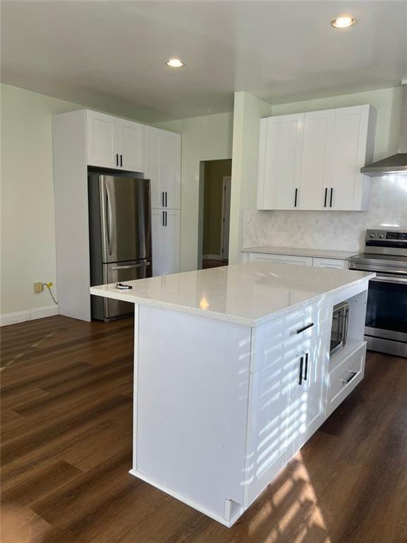 94 Cedar Valley Rd, Montezuma, GA 31063 - kitchen featuring stainless steel appliances, wall chimney exhaust hood, white cabinetry, dark wood-style floors, and recessed lighting