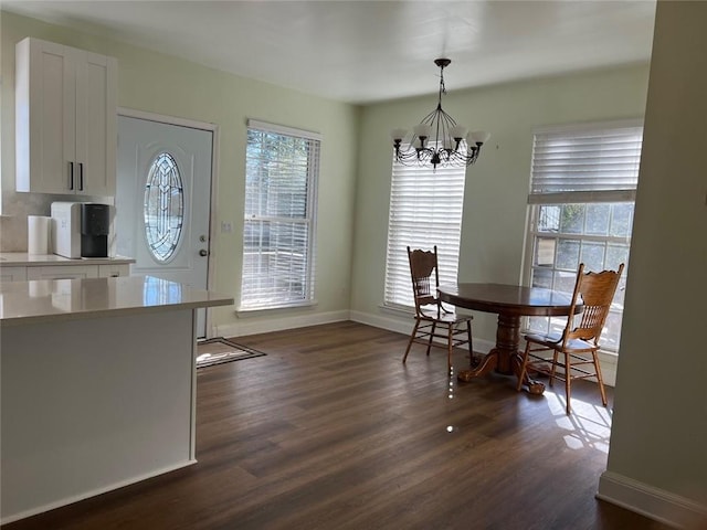 dining area featuring plenty of natural light, a chandelier, and dark hardwood / wood-style floors