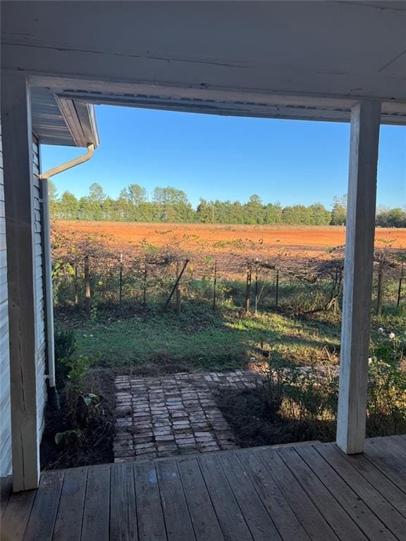 view of yard with a rural view and a deck