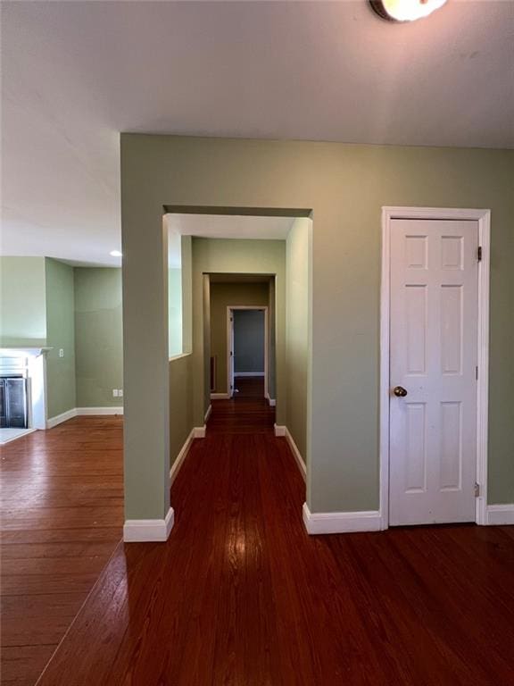 corridor with dark hardwood / wood-style floors