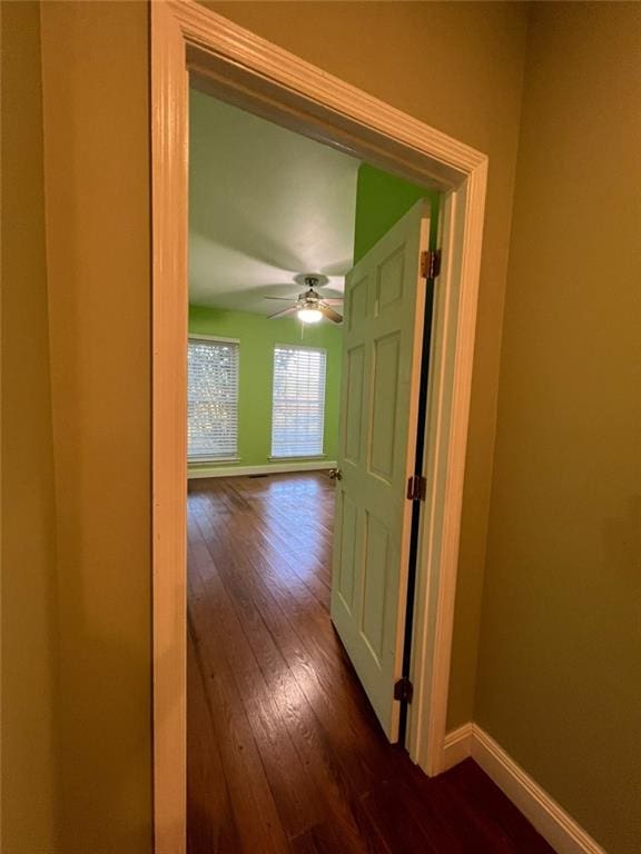 hallway with dark hardwood / wood-style flooring