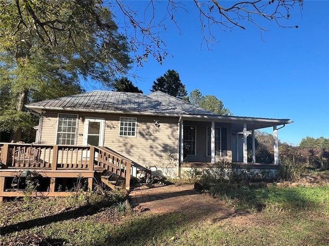 back of house with a deck