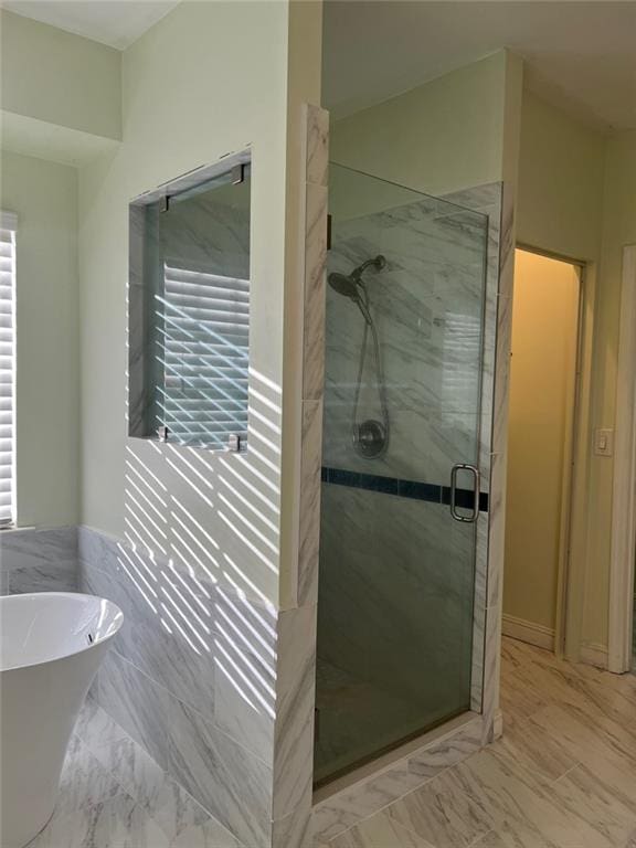 bathroom with separate shower and tub and a healthy amount of sunlight