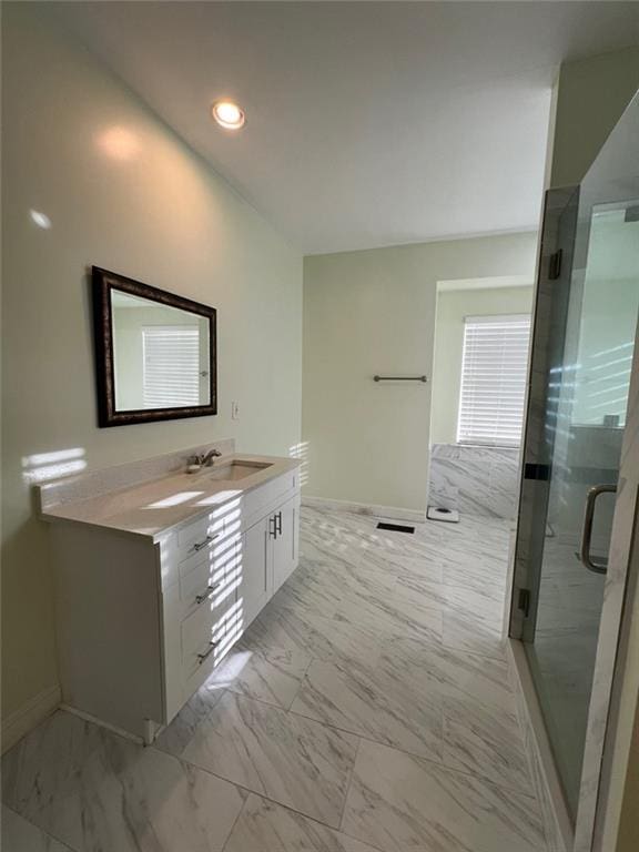 bathroom featuring vanity and an enclosed shower