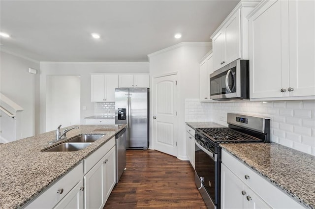 96 Quail Bend Way, Dallas, GA 30157 - kitchen with appliances with stainless steel finishes, a sink, white cabinets, dark wood-style floors, and ornamental molding