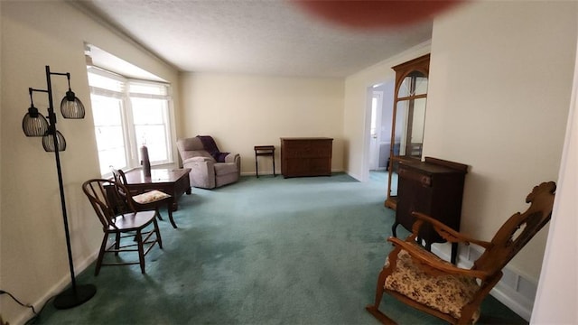 sitting room featuring baseboards and carpet