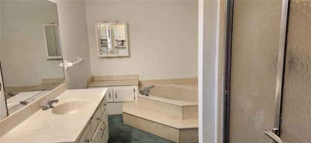 bathroom featuring vanity and a garden tub