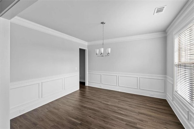 3717 Blue Goose Ln, Loganville, GA 30052 - unfurnished dining area featuring a chandelier, wainscoting, ornamental molding, dark wood-type flooring, and a decorative wall