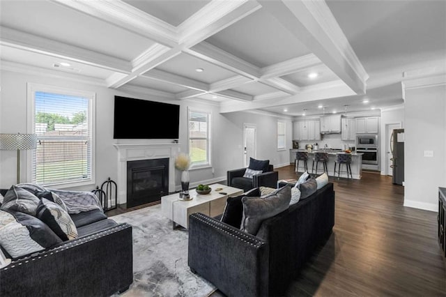 3717 Blue Goose Ln, Loganville, GA 30052 - living area with plenty of natural light, a glass covered fireplace, dark wood-style floors, beamed ceiling, and coffered ceiling