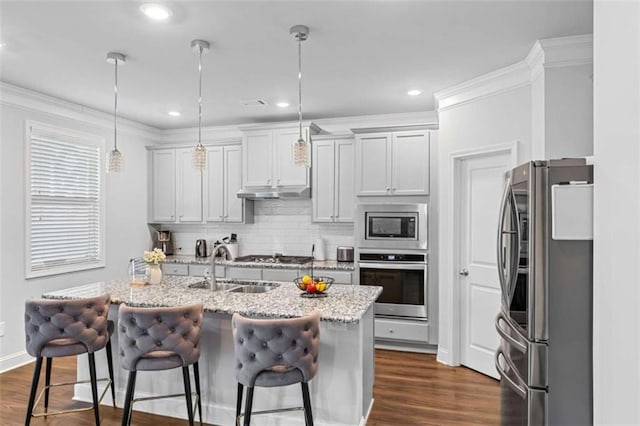 3717 Blue Goose Ln, Loganville, GA 30052 - kitchen with stainless steel appliances, decorative backsplash, dark wood finished floors, a breakfast bar, and recessed lighting
