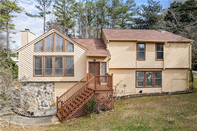 split foyer home with a front lawn