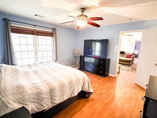 312 Henderson Mill Rd, Mansfield, GA 30055 - bedroom featuring ceiling fan, visible vents, baseboards, and wood finished floors