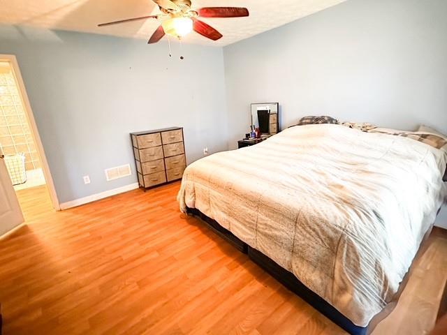 312 Henderson Mill Rd, Mansfield, GA 30055 - bedroom featuring visible vents, wood finished floors, baseboards, and ceiling fan