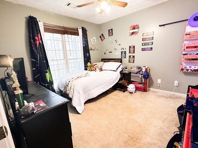 312 Henderson Mill Rd, Mansfield, GA 30055 - carpeted bedroom with visible vents, ceiling fan, and baseboards