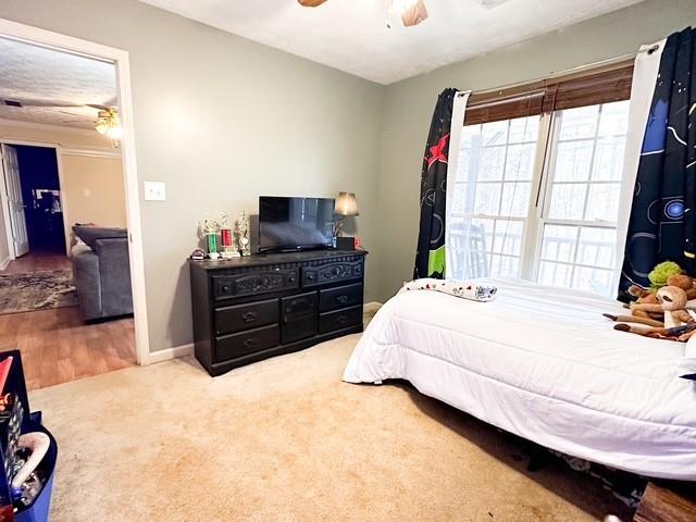 312 Henderson Mill Rd, Mansfield, GA 30055 - bedroom with carpet flooring, baseboards, and ceiling fan