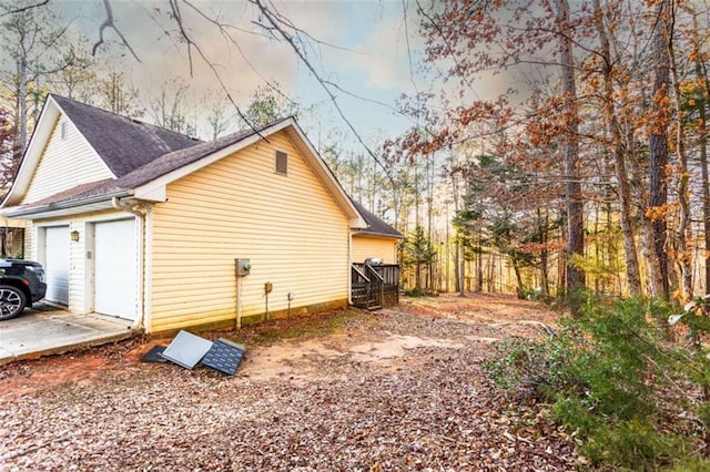 312 Henderson Mill Rd, Mansfield, GA 30055 - view of side of property with driveway, a garage, and roof with shingles