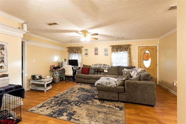 312 Henderson Mill Rd, Mansfield, GA 30055 - living area featuring visible vents, ceiling fan, ornamental molding, wood finished floors, and a textured ceiling