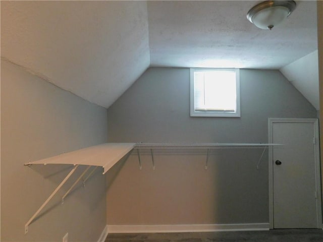 walk in closet featuring lofted ceiling