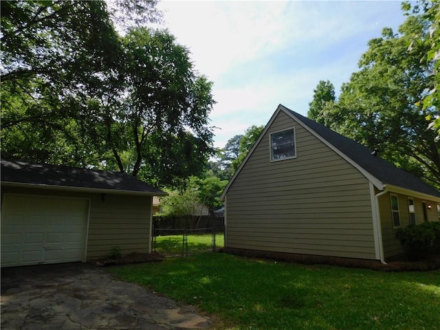 view of side of home with a garage and a yard