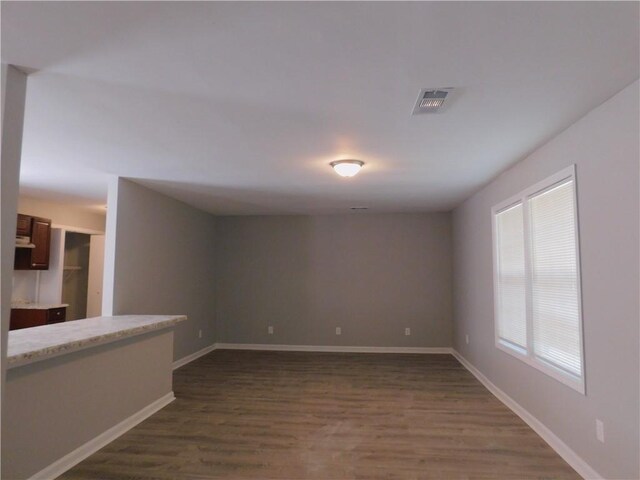 unfurnished room featuring dark wood-type flooring