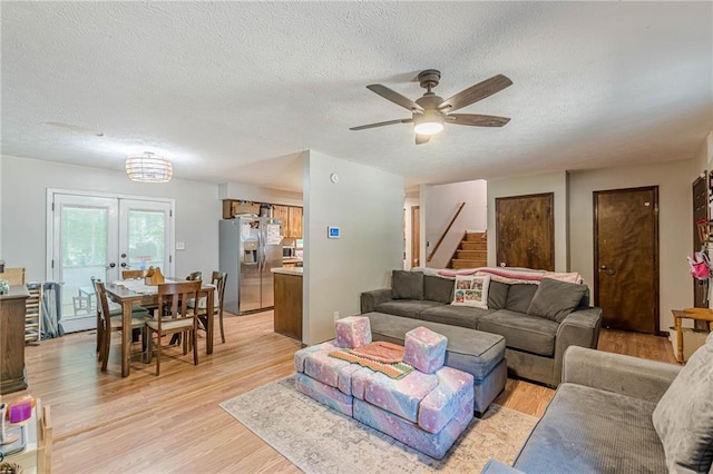 2642 Bridgehampton Rd SW, Marietta, GA 30064 - living room with light wood-type flooring, a textured ceiling, stairway, and a ceiling fan