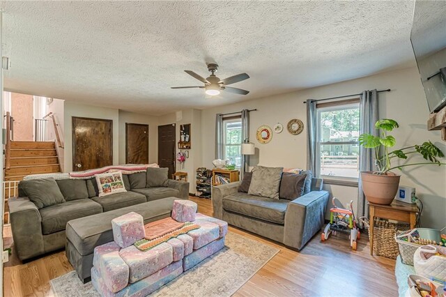 2642 Bridgehampton Rd SW, Marietta, GA 30064 - living area featuring a ceiling fan, stairway, light wood-style flooring, and a textured ceiling