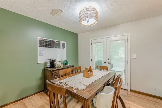 2642 Bridgehampton Rd SW, Marietta, GA 30064 - dining space with light wood-style floors, french doors, baseboards, and a textured ceiling