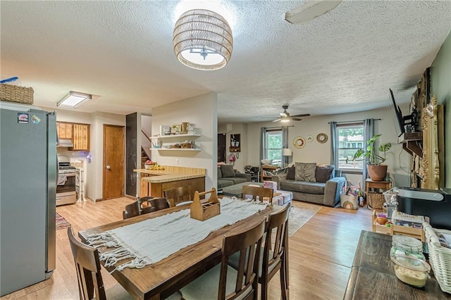 2642 Bridgehampton Rd SW, Marietta, GA 30064 - dining room with ceiling fan, a textured ceiling, and light wood-type flooring